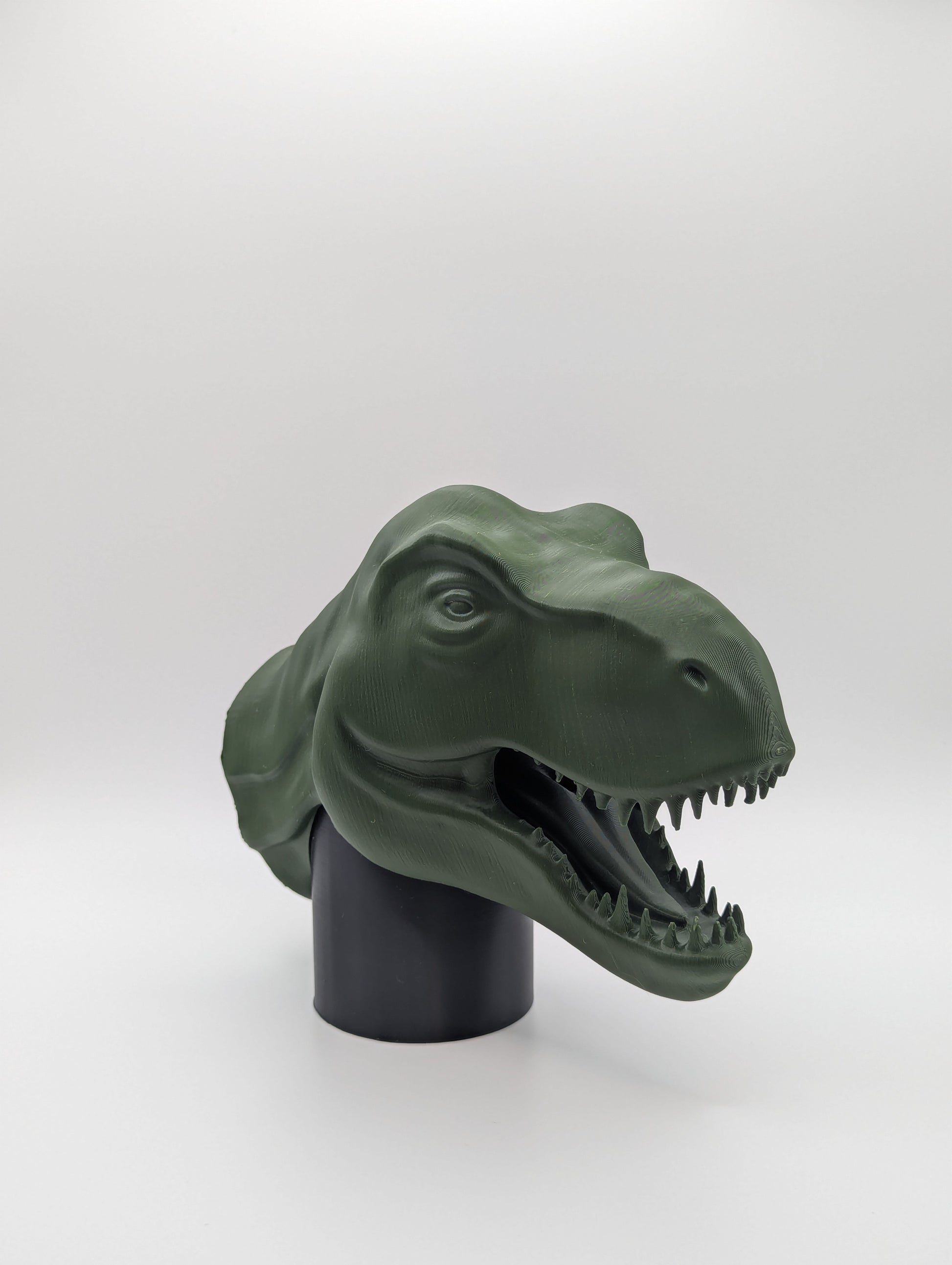 Green T-rex Dinosaur Tow Ball Cover viewed at an angle